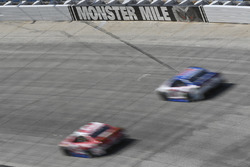 Cars race past the Monster Mile sign