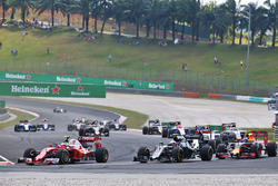 Kimi Raikkonen, Ferrari SF16-H and Jenson Button, McLaren MP4-31 at the start of the race