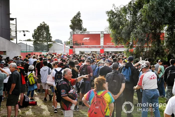 Fans queue at the delayed opening gates
