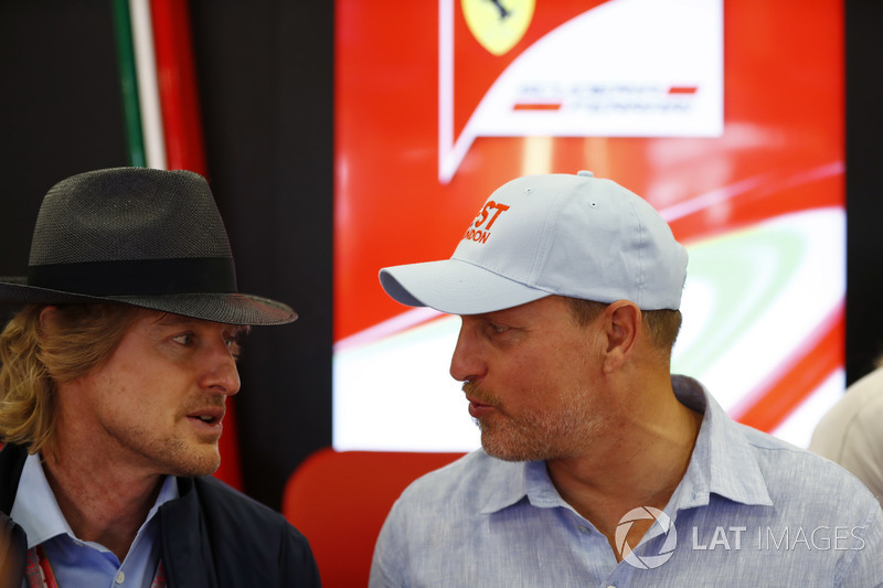 Owen Wilson and Woody Harrelson in the Ferrari garage