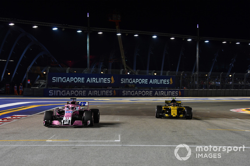 Sergio Perez, Racing Point Force India VJM11 and Carlos Sainz Jr., Renault Sport F1 Team R.S. 18 on the grid 