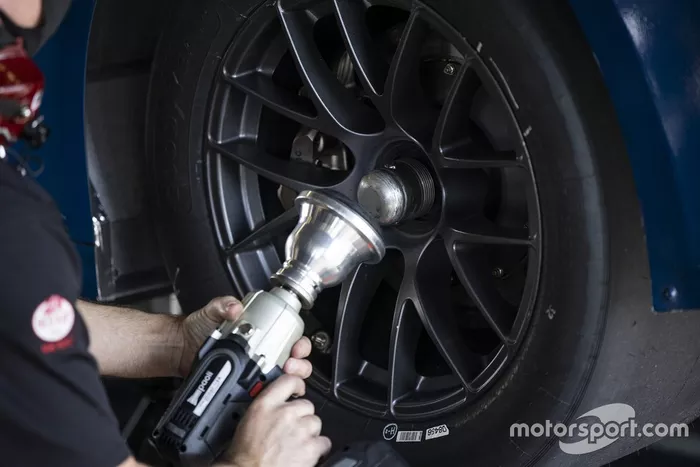 A team member makes adjustments to the NASCAR Next gen car