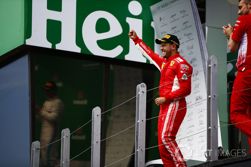 Sebastian Vettel, Ferrari, 1st position, celebrates as he arrives on the podium