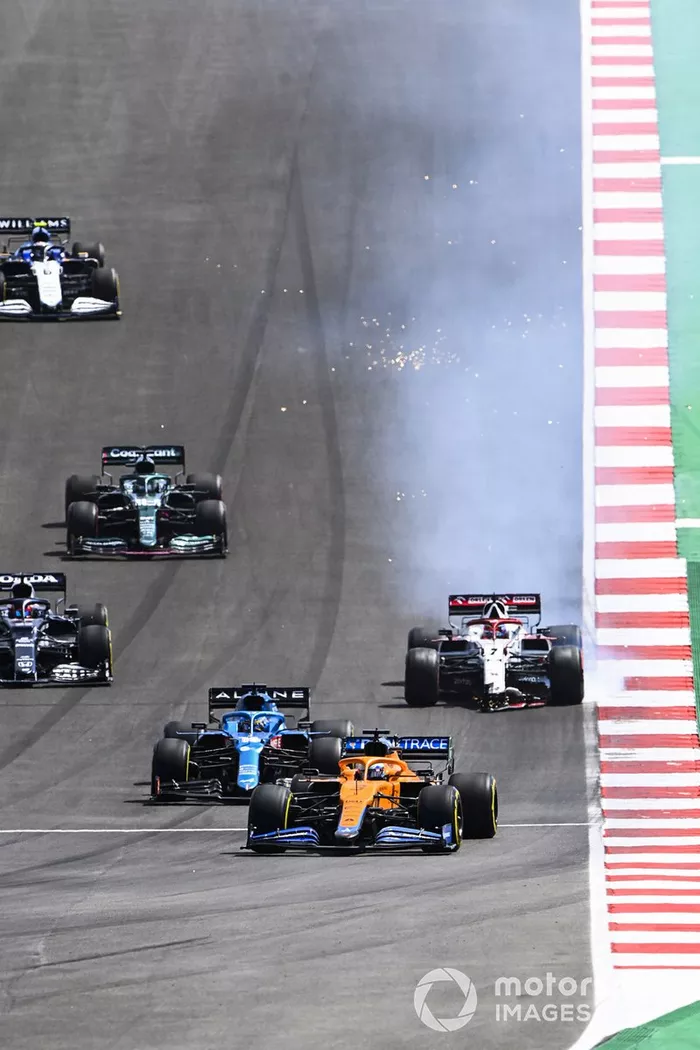Daniel Ricciardo, McLaren MCL35M, Fernando Alonso, Alpine A521, mientras Kimi Raikkonen, Alfa Romeo Racing C41, se detiene con daños en el alerón delantero
