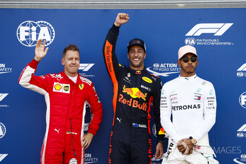 Daniel Ricciardo, Red Bull Racing, celebrates pole position between Sebastian Vettel, Ferrari, and Lewis Hamilton, Mercedes AMG F1