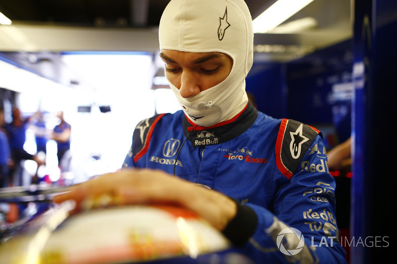 Pierre Gasly, Toro Rosso, adjusts his helmet.