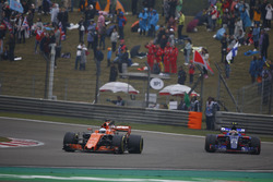 Fernando Alonso, McLaren MCL32, leads Carlos Sainz Jr., Scuderia Toro Rosso STR12