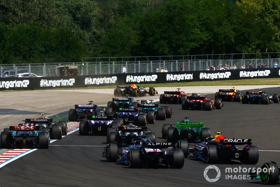 Lando Norris, McLaren MCL38, Lewis Hamilton, Mercedes F1 W15, Charles Leclerc, Ferrari SF-24, Carlos Sainz, Ferrari SF-24, reszta stawki na starcie, gdy Max Verstappen, Red Bull Racing RB20, przejeżdża szeroko.