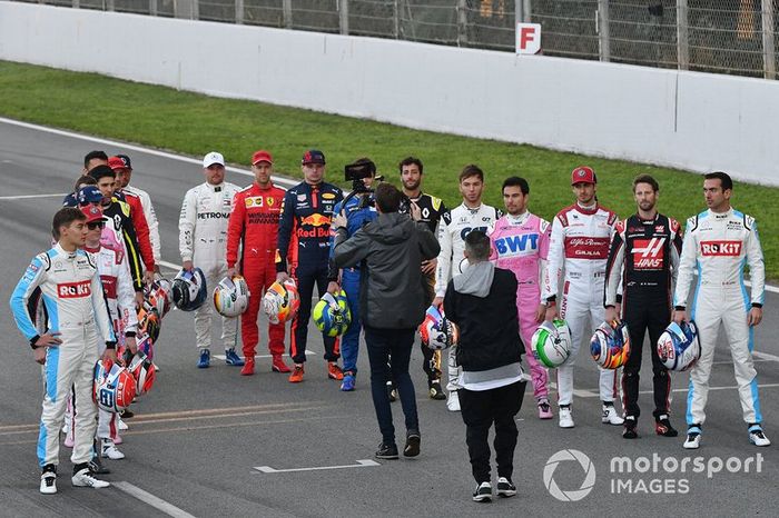 The drivers line up on the track