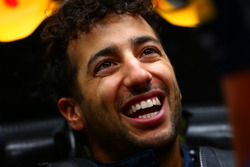 Daniel Ricciardo, Red Bull Racing smiles as he sits in his car in the garage