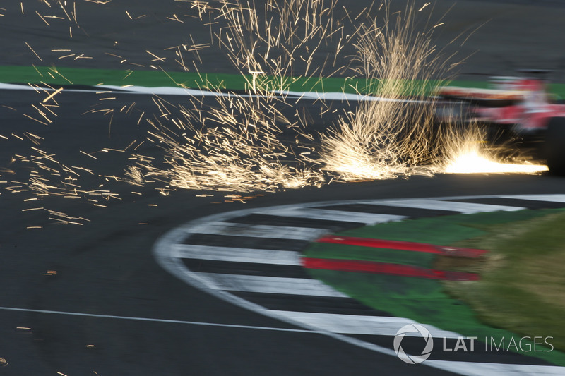 Sparks fly from the car of Sebastian Vettel, Ferrari SF70H