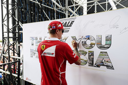 Kimi Raikkonen, Ferrari, signs an autograph on stage