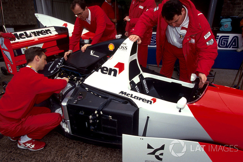 Mechanics work on the car of Ayrton Senna, McLaren Ford MP4/8