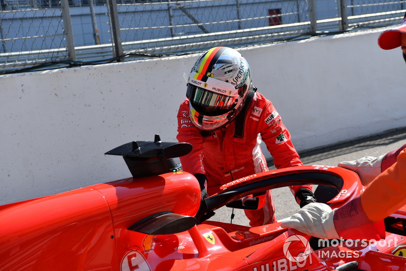 Sebastian Vettel, Ferrari pushes his car back in the pit lane