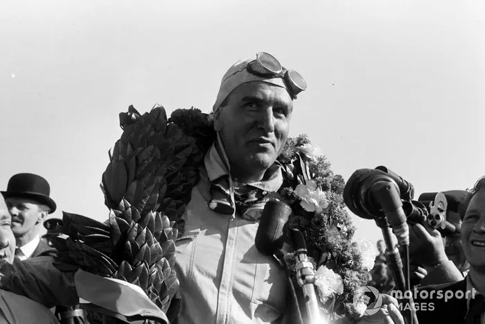 Giuseppe Farina with his winner's garland around his neck
