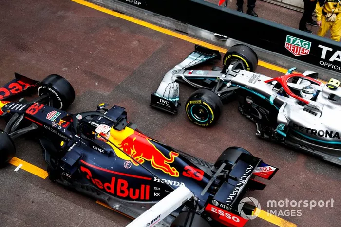 Max Verstappen, Red Bull Racing RB15, and Valtteri Bottas, Mercedes AMG W10, battle in the pit lane