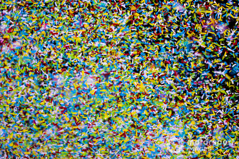 Ticker tape falls in abundance at the end of the race