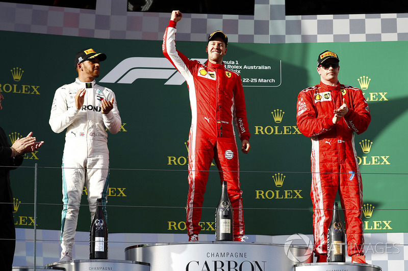 Sebastian Vettel, Ferrari, celebrates victory on the podium with second place Lewis Hamilton, Mercedes AMG F1, and third place Kimi Raikkonen, Ferrari