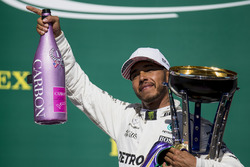 Race winner Lewis Hamilton, Mercedes AMG F1, with his pink Champagne bolt and trophy on the podium