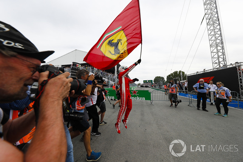 Sebastian Vettel, Ferrari, celebrates victory by waving a Prancing Horse flag