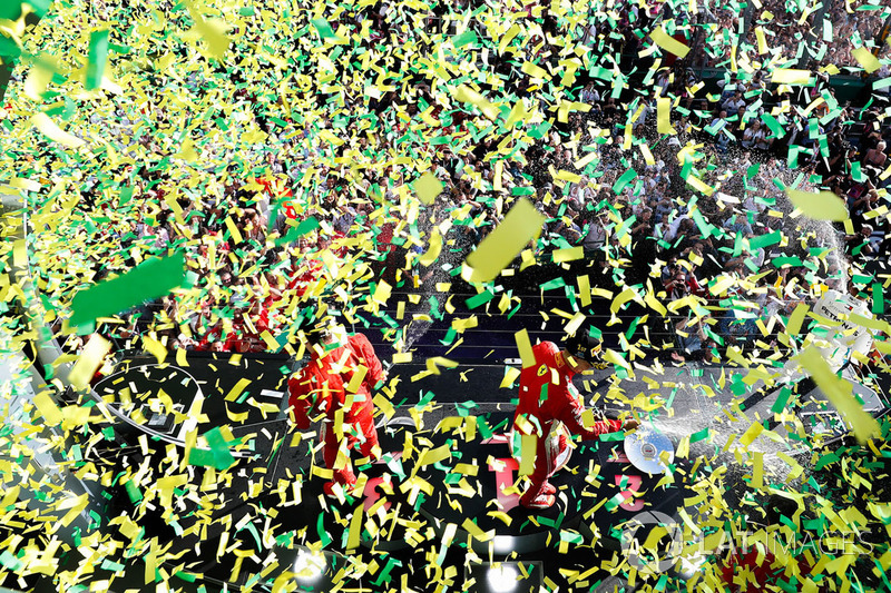 Race winner Sebastian Vettel, Ferrari, second place Lewis Hamilton, Mercedes AMG F1, third place, Kimi Raikkonen, Ferrari, celebrate on the podium as confetti rains down