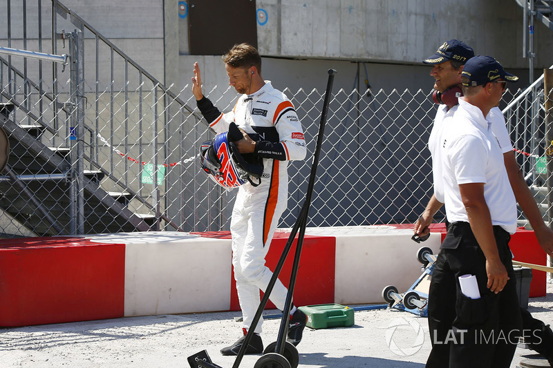  Jenson Button, McLaren, walks back to the pits after retiring from the race