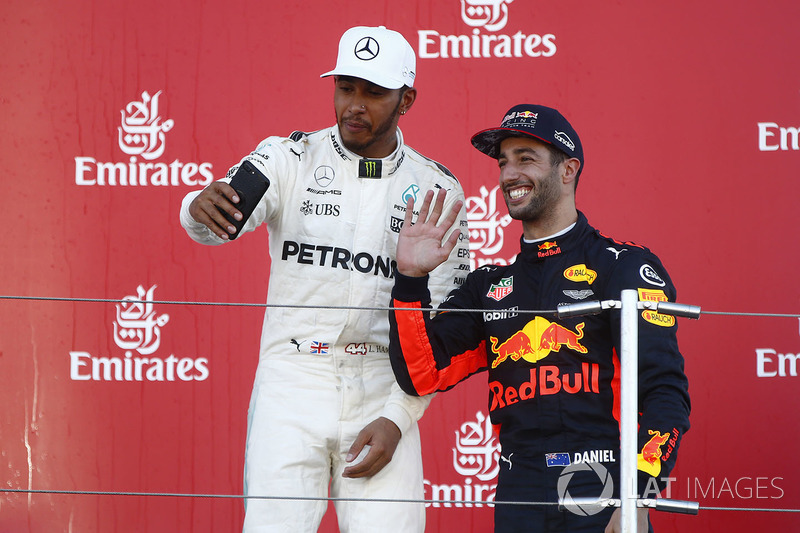 Race winner Third place Lewis Hamilton, Mercedes AMG F1 Daniel Ricciardo, Red Bull Racing, take a photo on the podium