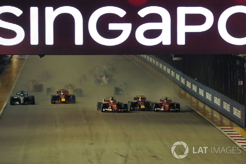 Sebastian Vettel, Ferrari SF70H leads at the start of the race and the cars of Kimi Raikkonen, Ferrari SF70H and Max Verstappen, Red Bull Racing RB13 crash after colliding