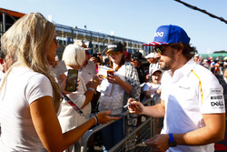 Fernando Alonso, McLaren, signs autographs for fans
