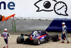 Marshals attend to Pierre Gasly, Toro Rosso STR13, after he suffered broken suspension