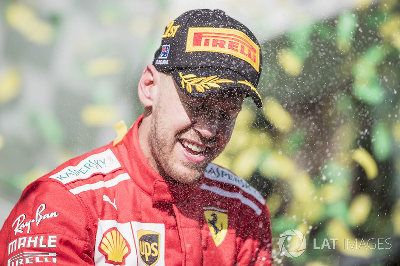 Sebastian Vettel, Ferrari, 1st position, celebrates on the podium with Champagne