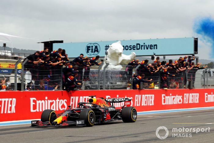 Max Verstappen, Red Bull Racing, posisi pertama, melewati garis finis dan disambut sorak-sorai timnya di dinding pit