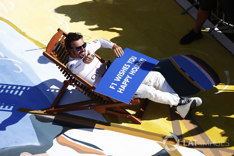 Fernando Alonso, McLaren, relaxes on a deckchair in parc ferme