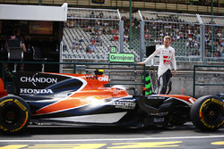 Kevin Magnussen, Haas F1 Team, descend du muret des stands au moment où passe Stoffel Vandoorne, McLaren MCL32