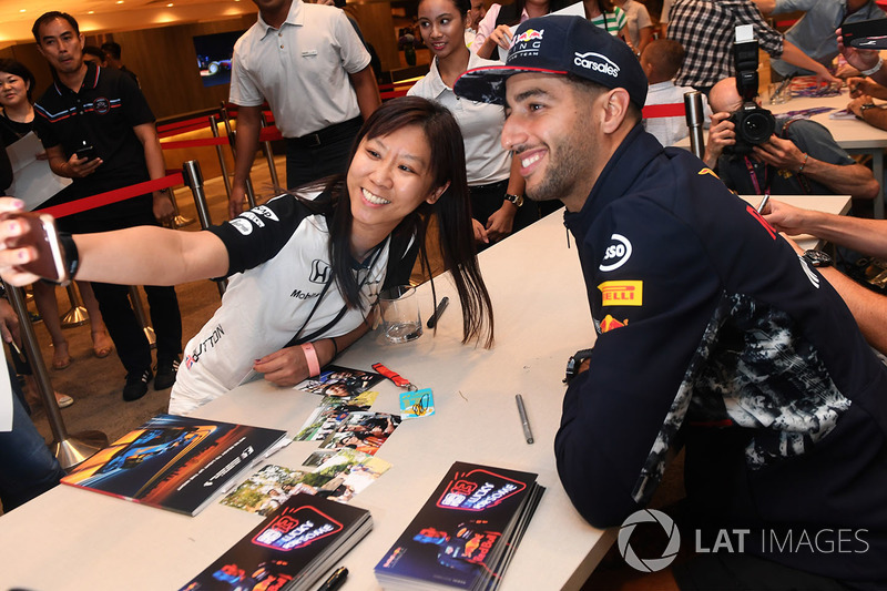 Daniel Ricciardo, Red Bull Racing at the autograph session and poses for a selfie photo