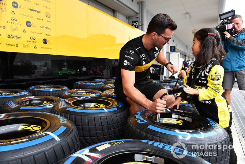 Renault Sport F1 Team mechanic with Pirelli tyres and young fans