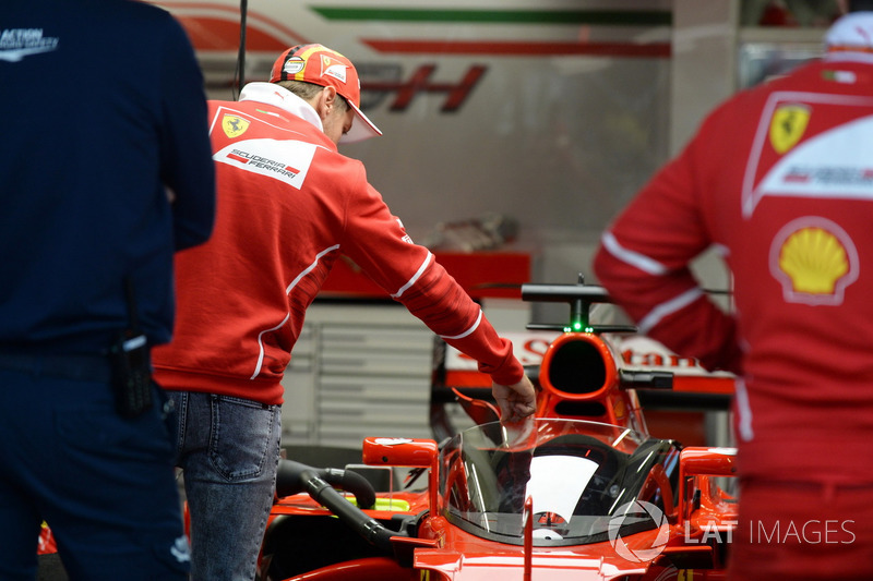 Sebastian Vettel, Ferrari looks at Ferrari SF70-H with cockpit shield