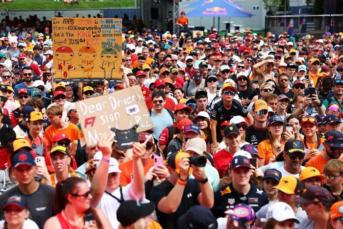 Fans gather by the fan forums stage.