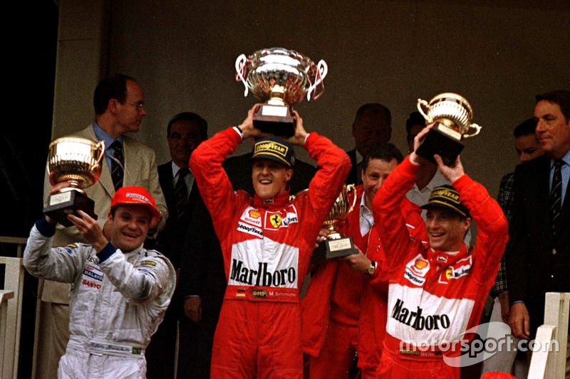 Podium: Race winner Michael Schumacher, Ferrari F310B; second place Rubens Barrichello, Stewart SF1 Ford; third place Eddie Irvine, Ferrari F310B