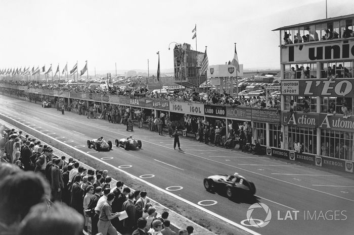 Juan Manuel Fangio, Maserati 250F, leads Stirling Moss, Vanwall VW10