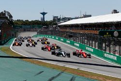 Valtteri Bottas, Mercedes-Benz F1 W08 and Sebastian Vettel, Ferrari SF70H battle at the start of th