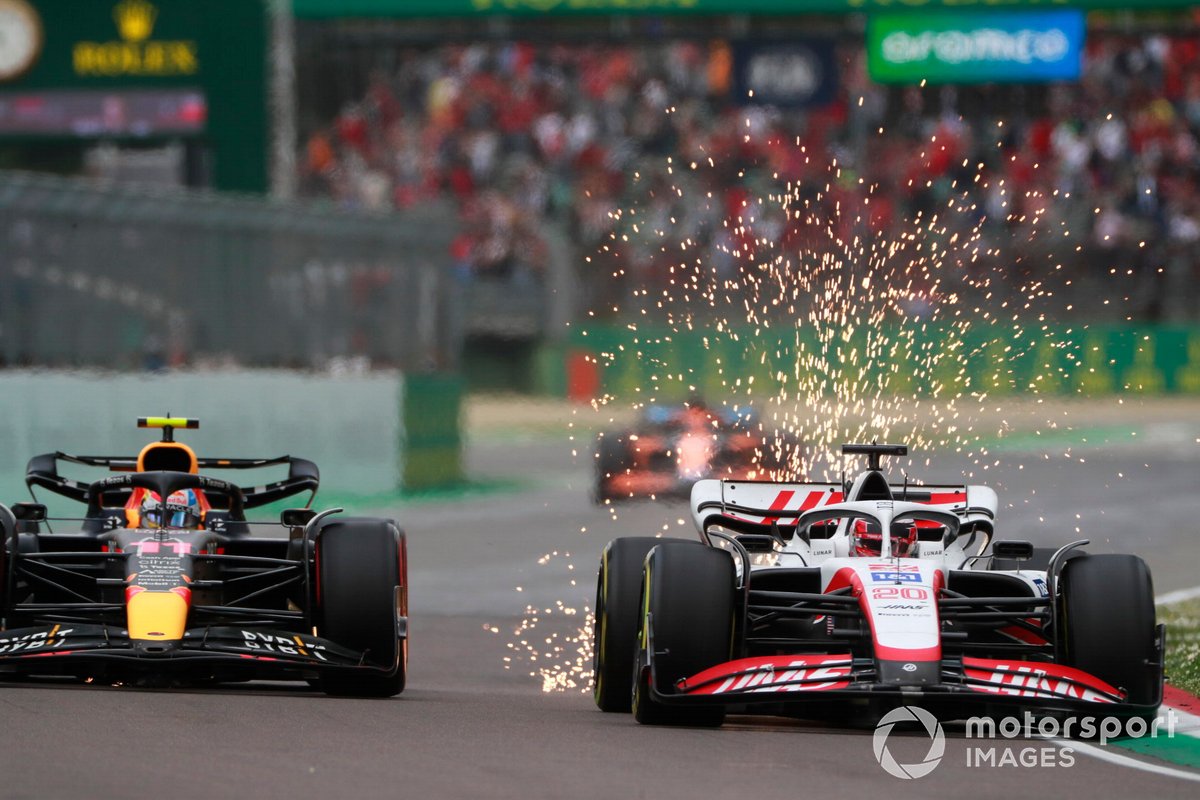 Sparks fly as Kevin Magnussen, Haas VF-22, Sergio Perez, Red Bull Racing RB18