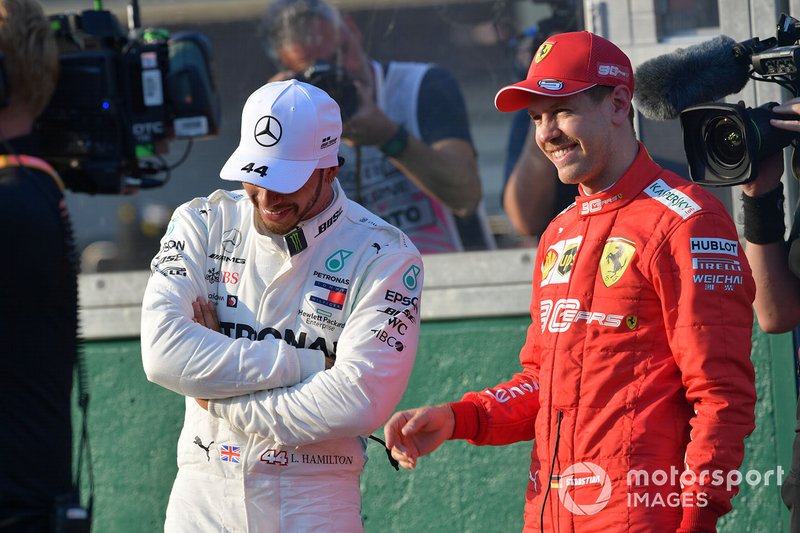 Lewis Hamilton, Mercedes AMG F1, and Sebastian Vettel, Ferrari, talk after qualifying