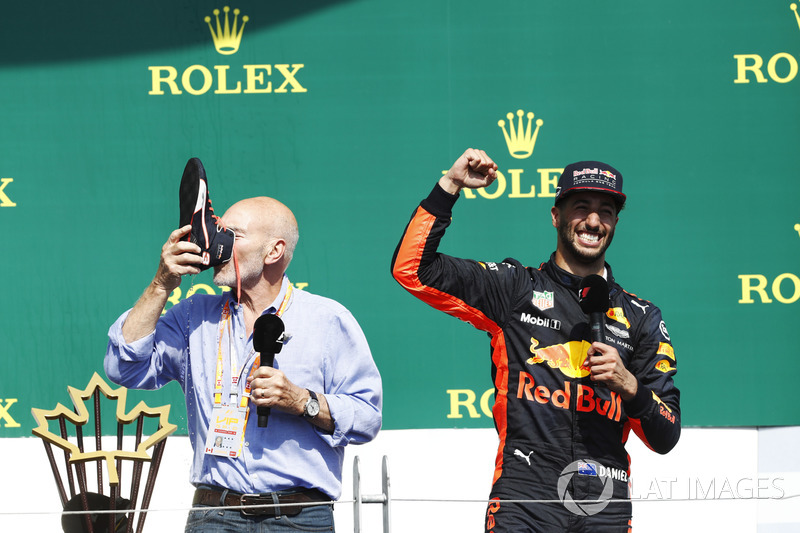 Sir Patrick Stewart drinks champagne from the shoe of Daniel Ricciardo, Red Bull Racing, on the podi