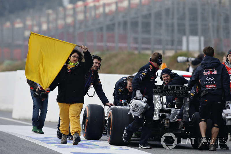 The Red Bull team push Daniil Kvyat, Red Bull Racing RB11, back to his garage