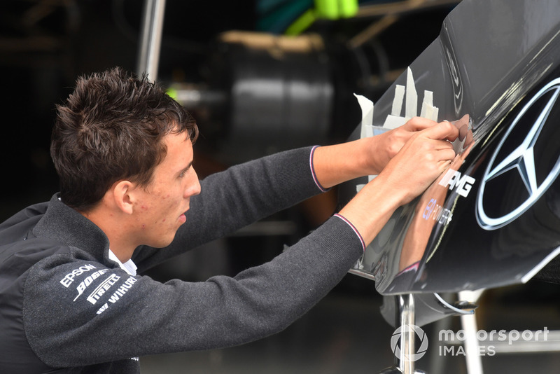 Mercedes-AMG F1 mechanics applies logos to Mercedes-AMG F1 W09 bodywork