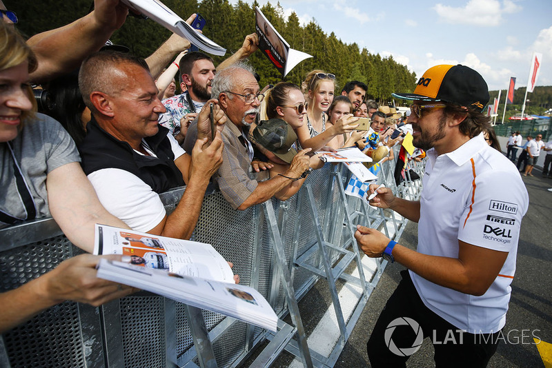 Fernando Alonso, McLaren, signs autographs for fans