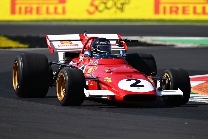 Jacky Ickx drives a Ferrari 312B on track.
