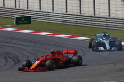 Kimi Raikkonen, Ferrari SF71H, leads Lewis Hamilton, Mercedes AMG F1 W09