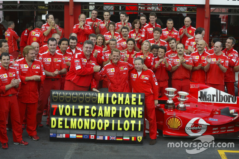 Michael Schumacher, Ferrari F2004 celebrates with the Ferrari team after winning his 7th world champ